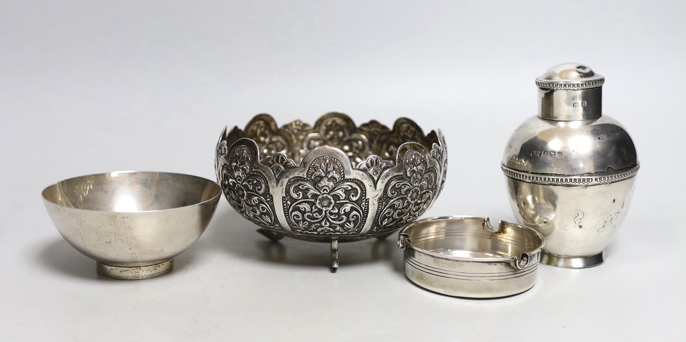 An Indian embossed white metal bowl, diameter 12.9cm, a George V silver tea caddy?, a modern silver Links of London small bowl and an 800 white metal ashtray.